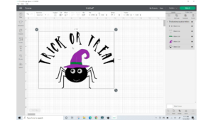 photo of a computer screen with cricut design space in use and a svg image of a spider with the words trick or treat about his head